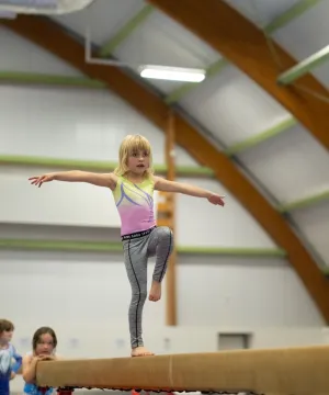 girl on gymnastics beam 