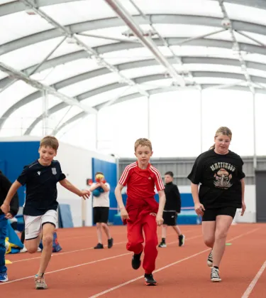 kids running on athletics track 