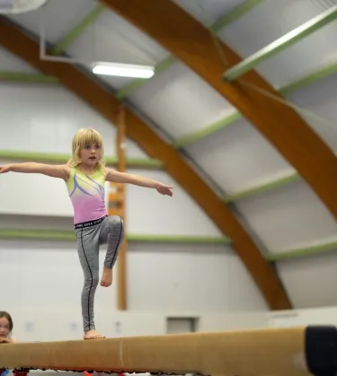 girl on gymnastics beam 