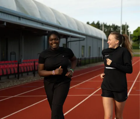 girls running on track 