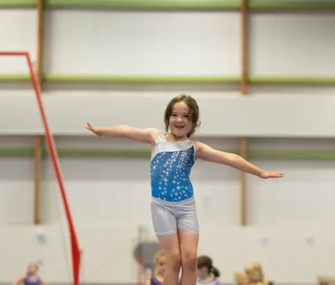 girl on gymnastics beam 